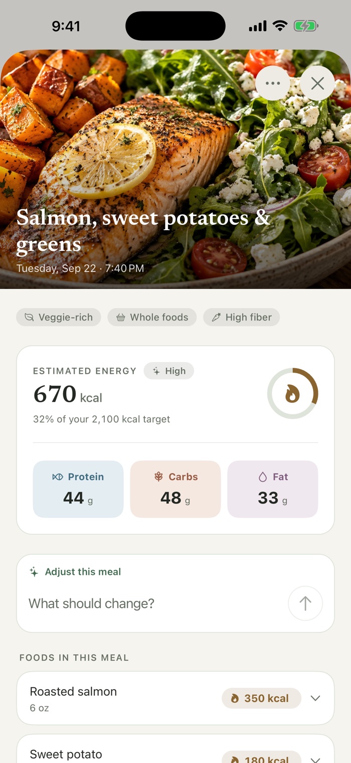 A salmon, sweet potato, and greens meal photo with an estimate of 670 calories, 44 grams of protein, 48 grams of carbs, and 33 grams of fat, plus a field to adjust the meal.